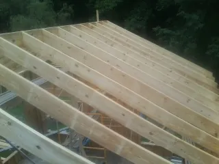 New roof rafters set over an addition before sheathing in Vienna
